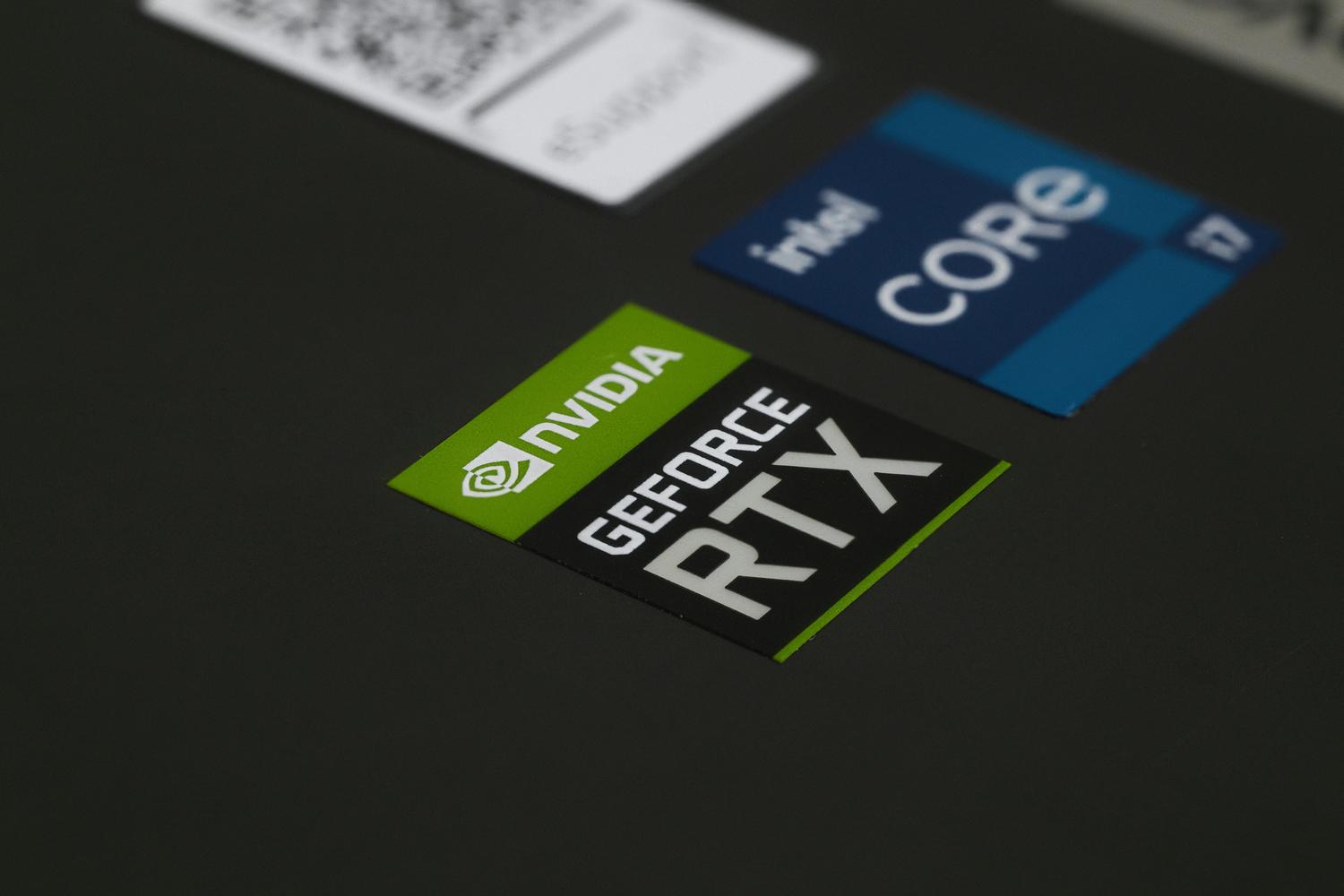 Close-up of NVIDIA GeForce RTX and Intel Core i7 stickers on a laptop, illustrating high-performance hardware.