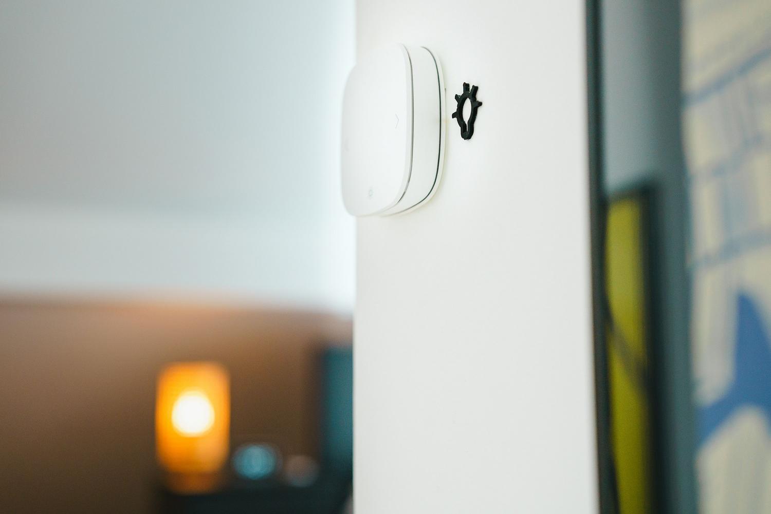 Interruptor de luz inteligente instalado en una pared blanca, simbolizando la automatización y el ahorro energético en el hogar.