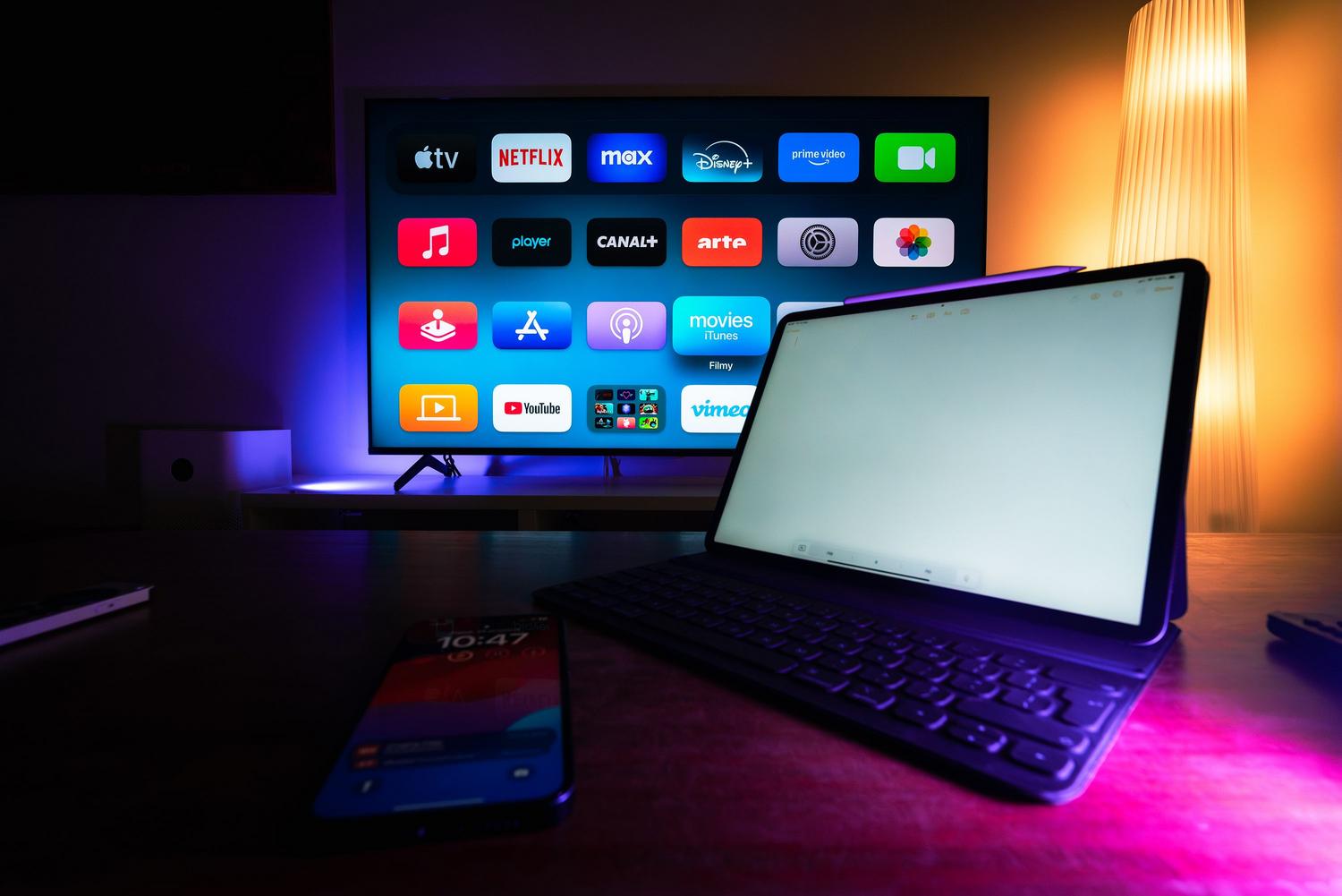 A modern home setup with a smart TV and tablet, showing multiple devices competing for internet bandwidth.