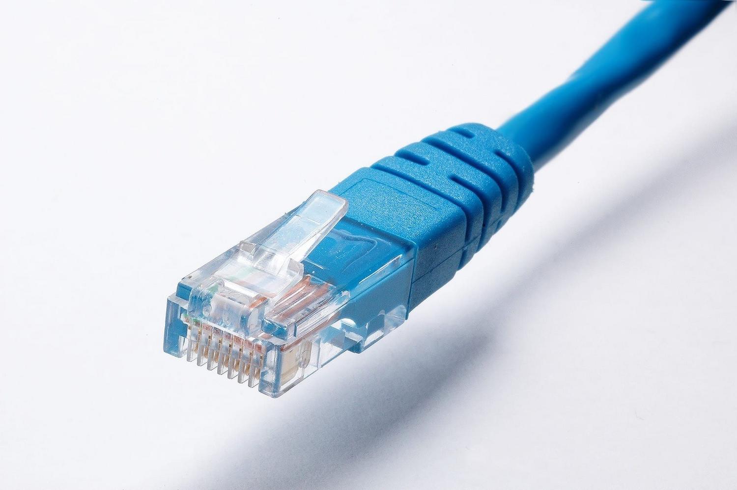 Close-up of a blue Ethernet cable plug, the best alternative for stable 4K streaming on Smart TVs.
