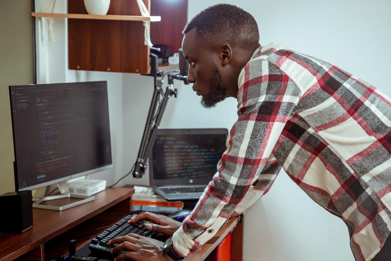 A focused IT specialist working at a computer in a modern office setting, representing professional software integration and DevOps workflows.