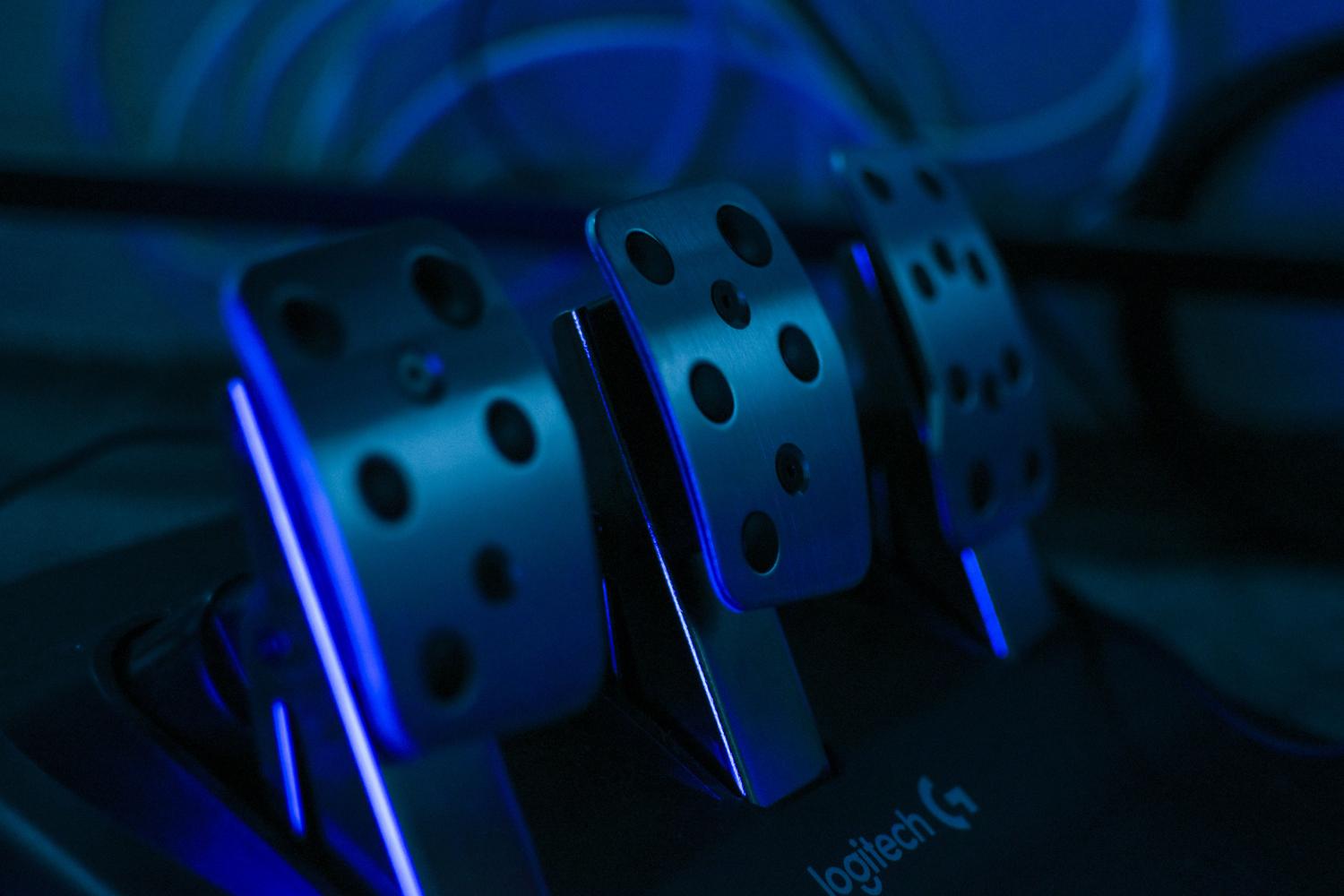 Detalle de pedales de simracing con iluminación RGB, esenciales para el control preciso en simuladores.
