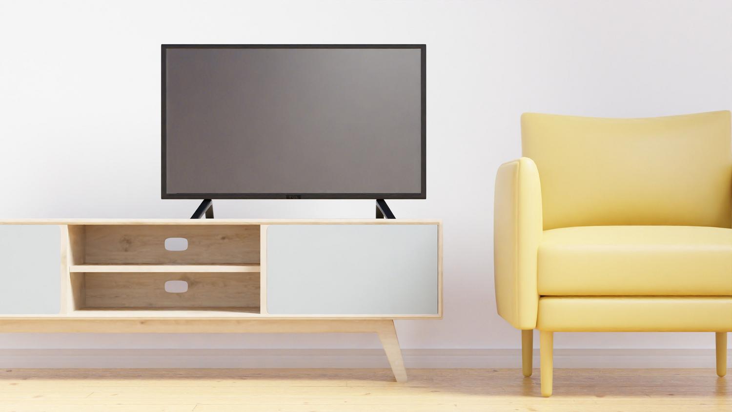 Salón minimalista con televisor de pantalla plana y mobiliario moderno.