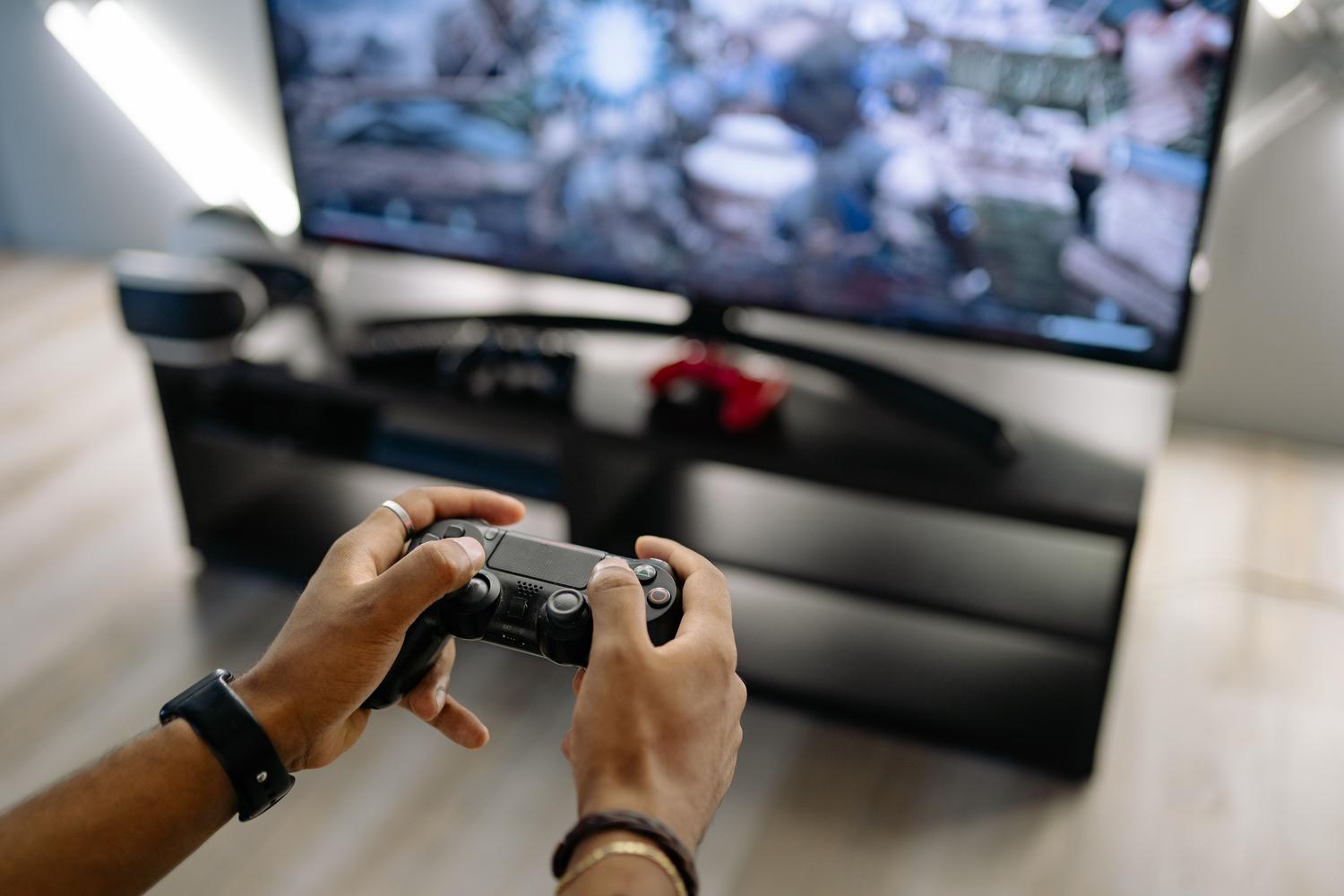 Primer plano de unas manos sosteniendo un mando de consola mientras juega en PC.