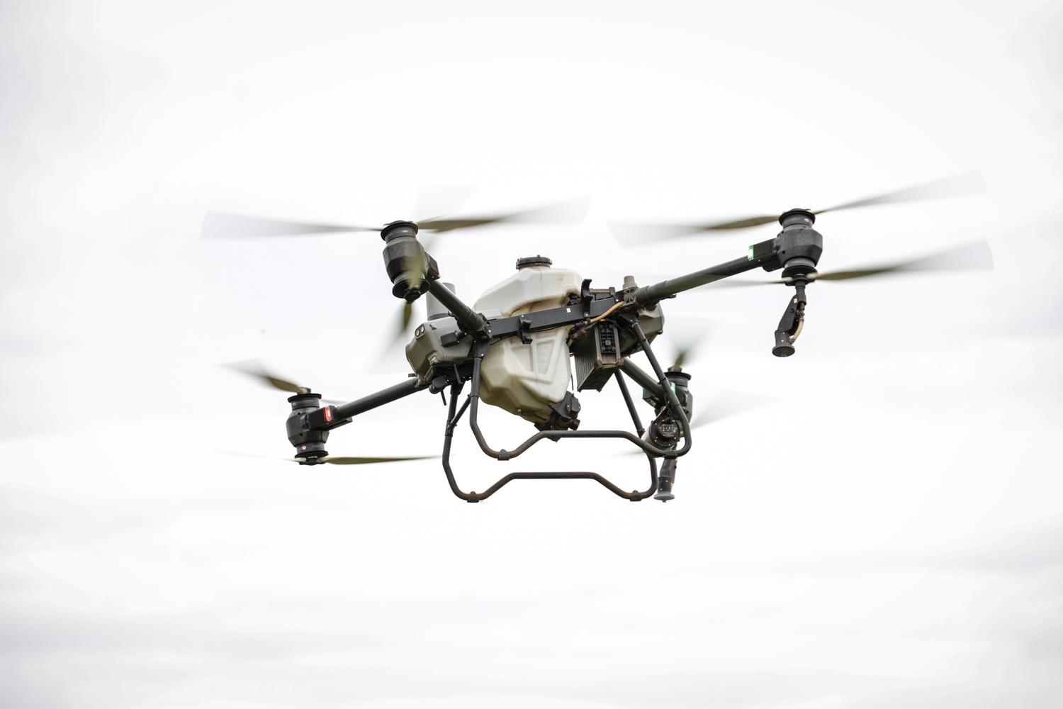 Dron especializado en agricultura de precisión volando sobre un campo, ilustrando la aplicación de la fotogrametría en el sector agrario.